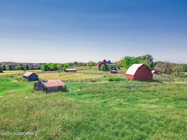 view of yard featuring a rural view and an outdoor structure