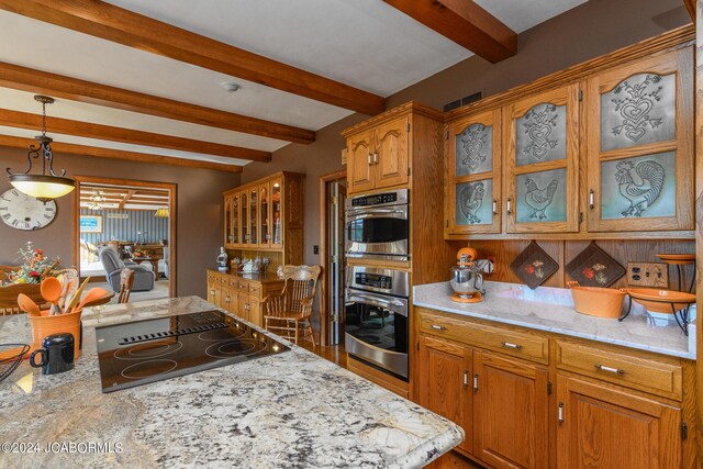 kitchen with stainless steel double oven, light stone counters, beamed ceiling, pendant lighting, and black electric cooktop