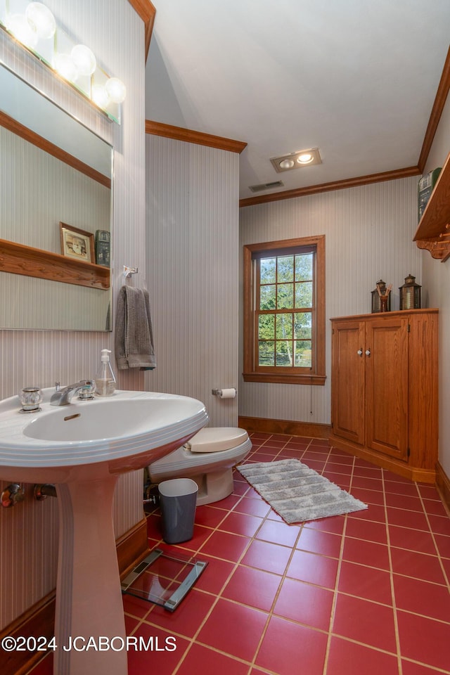 bathroom featuring tile patterned flooring, toilet, and ornamental molding