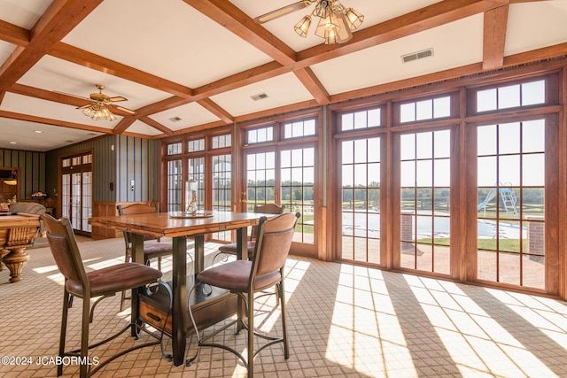 dining space with beam ceiling, ceiling fan, french doors, and coffered ceiling