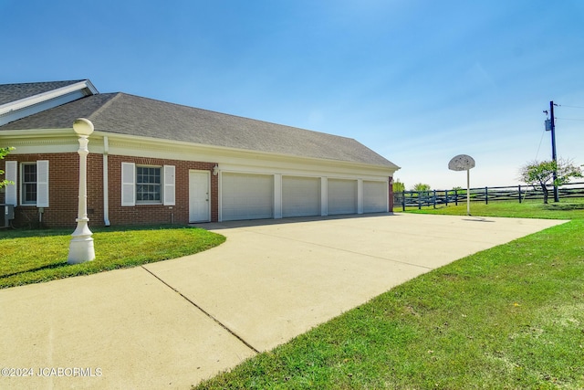 view of side of property with a yard and a garage