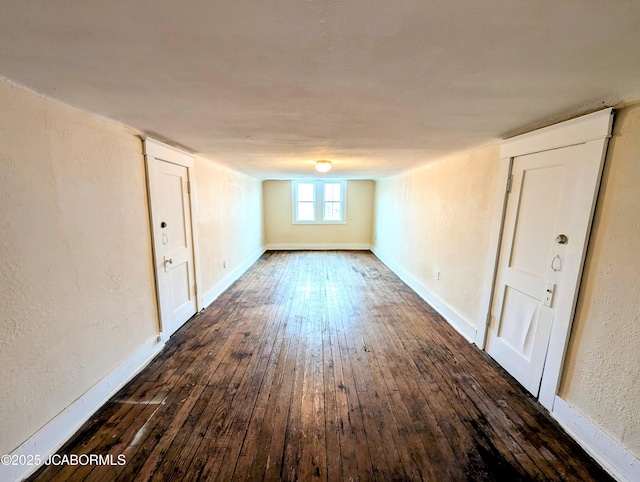 spare room featuring dark wood-type flooring