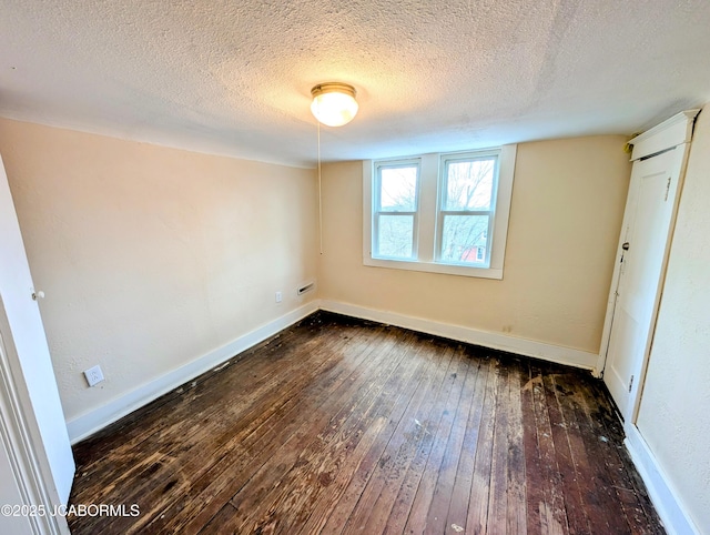 interior space with dark hardwood / wood-style floors and a textured ceiling