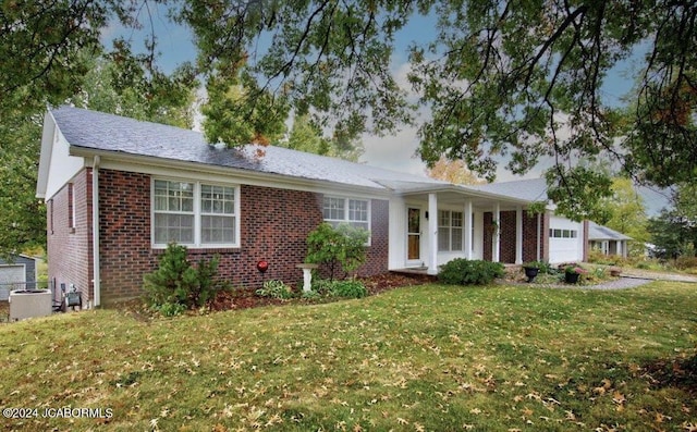 ranch-style house with central AC, a front yard, and a garage