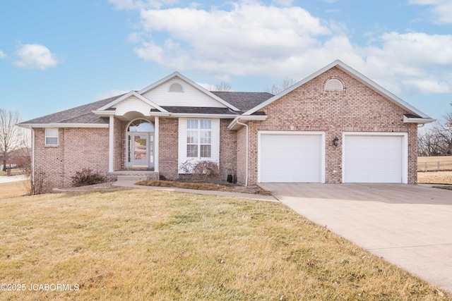 ranch-style home with an attached garage, brick siding, driveway, roof with shingles, and a front lawn