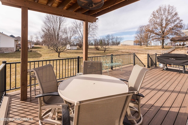 wooden terrace with outdoor dining area and a grill