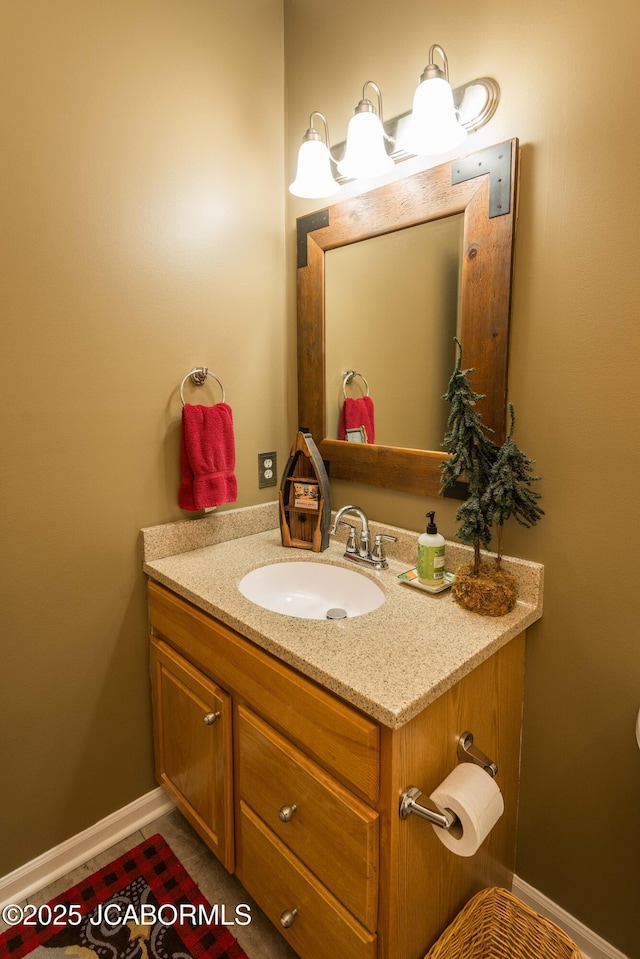 bathroom with baseboards and vanity