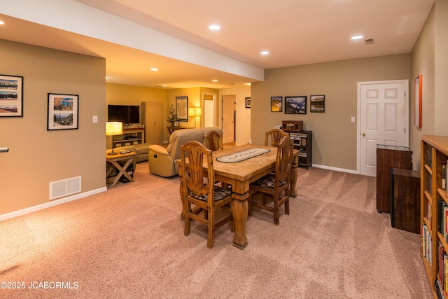 dining room with light carpet, baseboards, visible vents, and recessed lighting