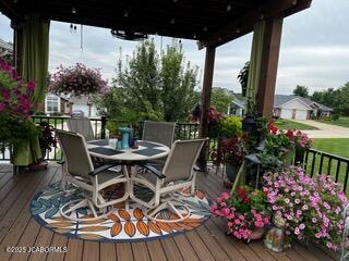 wooden terrace with outdoor dining area