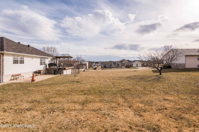 view of yard featuring a wooden deck and a patio