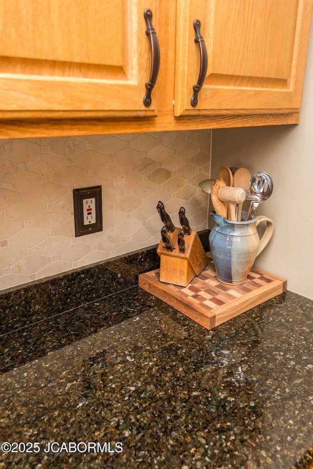 interior details with dark stone counters and backsplash