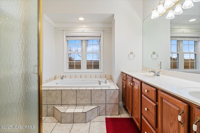 bathroom featuring a sink, double vanity, tile patterned flooring, and a bath