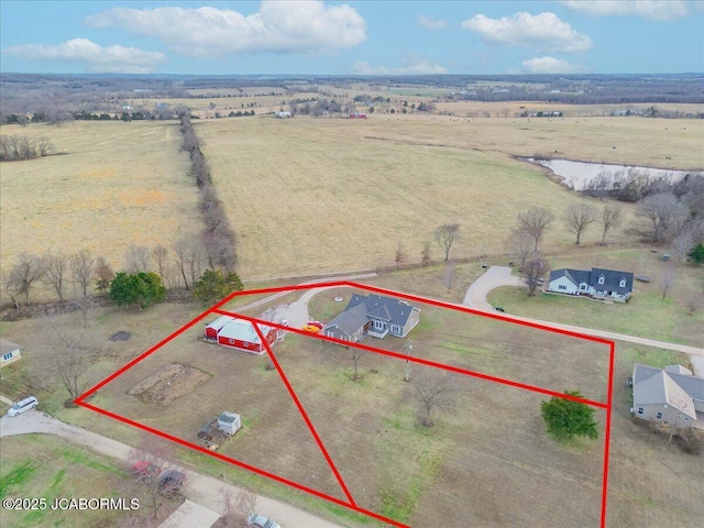 birds eye view of property with a rural view