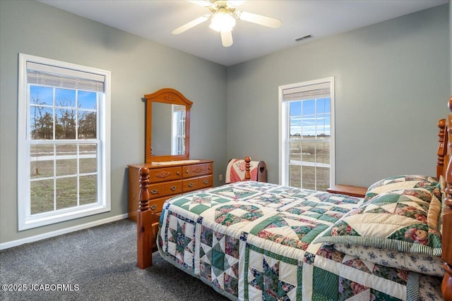 carpeted bedroom featuring ceiling fan, visible vents, and baseboards