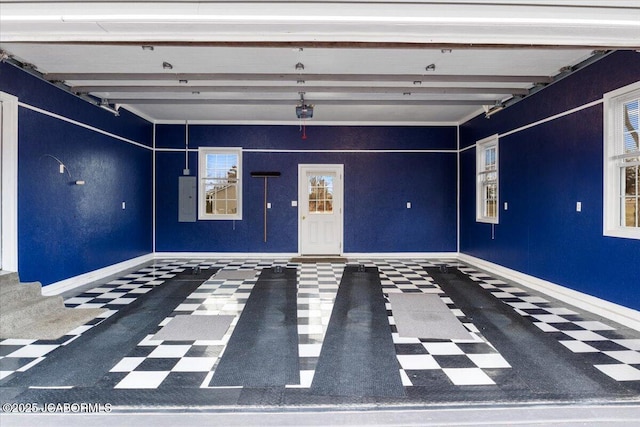 garage with electric panel and baseboards