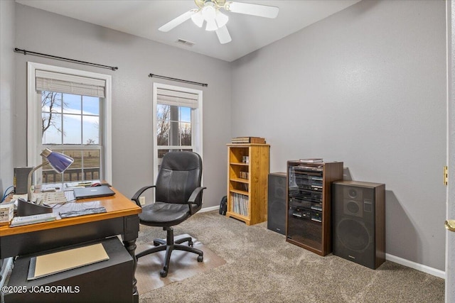 carpeted office featuring ceiling fan, visible vents, and baseboards