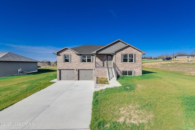 view of front of property with central air condition unit, a front lawn, and a garage