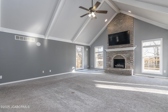 unfurnished living room featuring visible vents, baseboards, carpet floors, beam ceiling, and high vaulted ceiling