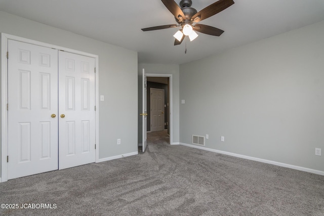 unfurnished bedroom featuring a closet, visible vents, baseboards, and carpet