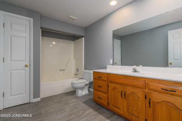 bathroom with visible vents, toilet, wood finished floors, and vanity