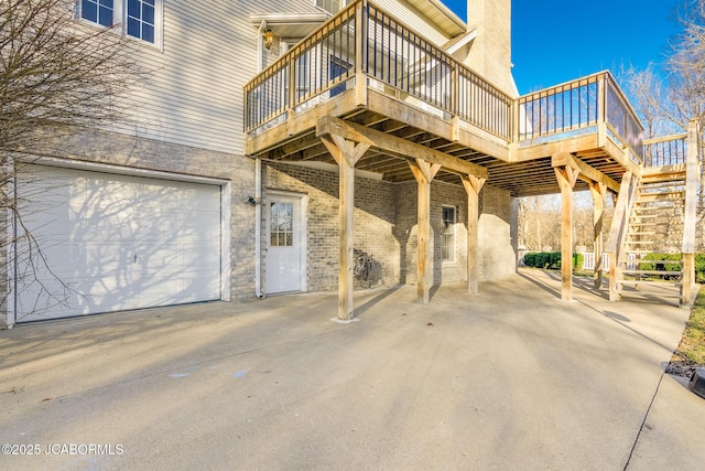 view of patio with stairway, a garage, and a wooden deck