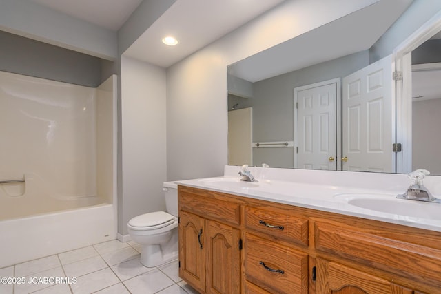 full bathroom with a sink, toilet, double vanity, and tile patterned flooring