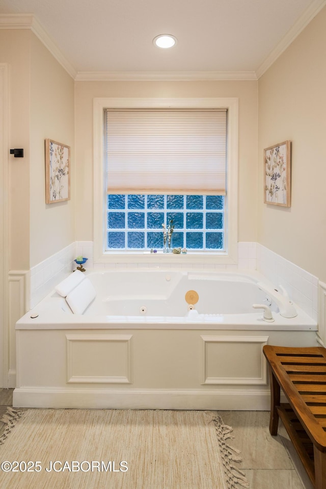 bathroom with ornamental molding and a bathtub