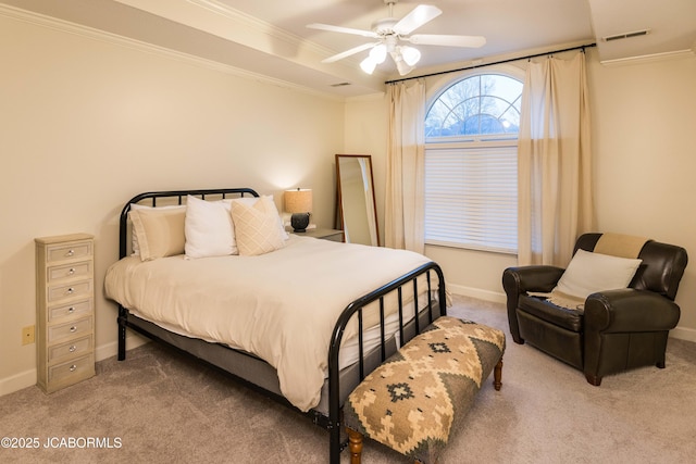 carpeted bedroom with ornamental molding and ceiling fan