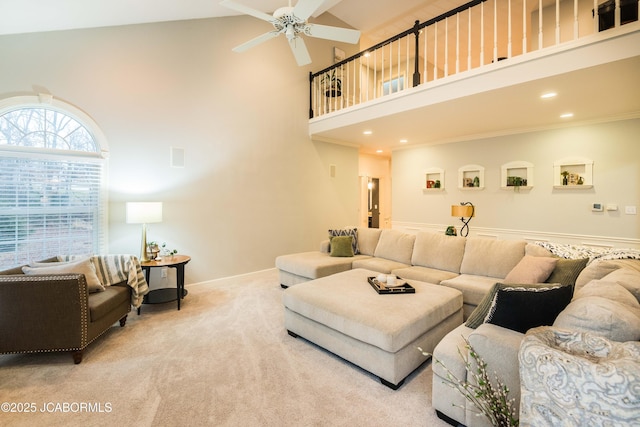 living room with ceiling fan, light carpet, and a high ceiling