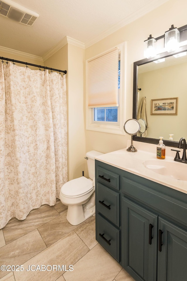 bathroom featuring crown molding, vanity, and toilet