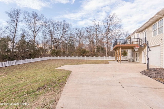 view of yard with a garage and a deck