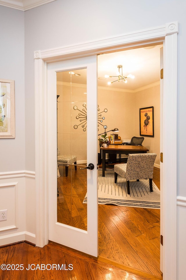 interior space featuring french doors, ornamental molding, and hardwood / wood-style floors