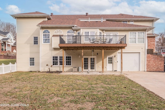 back of house featuring a patio, a deck, a lawn, a garage, and central air condition unit