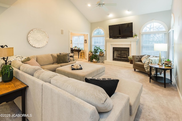 living room with light carpet, high vaulted ceiling, and ceiling fan