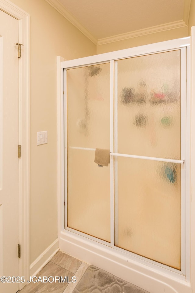 bathroom with tile patterned flooring, crown molding, and an enclosed shower