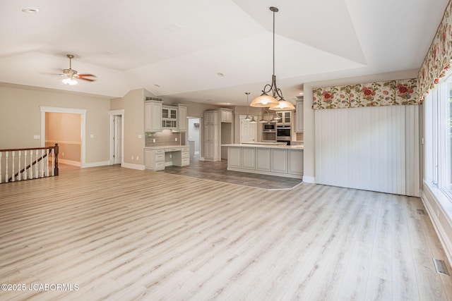 4205 Grant Ln, Columbia, MO 65203 - unfurnished living room featuring vaulted ceiling, light wood-style flooring, and ceiling fan