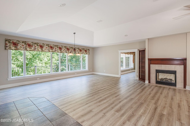 4205 Grant Ln, Columbia, MO 65203 - unfurnished living room with plenty of natural light, a raised ceiling, light wood-type flooring, and a fireplace