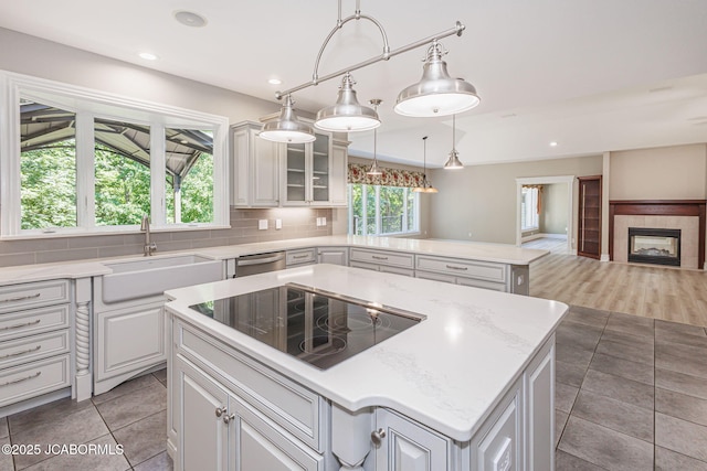 4205 Grant Ln, Columbia, MO 65203 - kitchen featuring black electric stovetop, plenty of natural light, a kitchen island, open floor plan, and recessed lighting