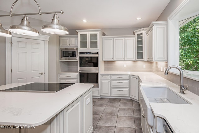 4205 Grant Ln, Columbia, MO 65203 - kitchen featuring stainless steel appliances, plenty of natural light, white cabinets, and recessed lighting