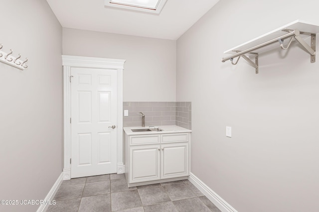 4205 Grant Ln, Columbia, MO 65203 - washroom featuring a sink and light tile patterned flooring