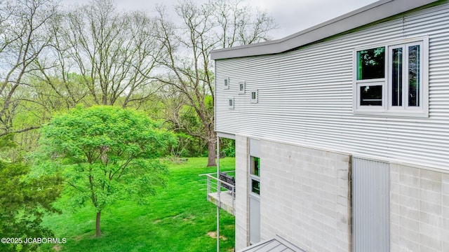 view of side of home featuring a lawn