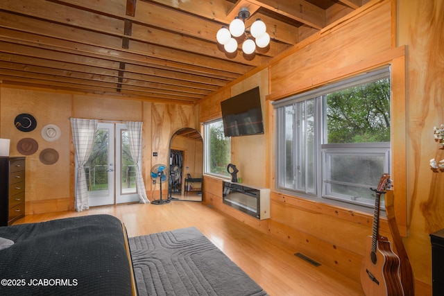 living room with visible vents, french doors, wood finished floors, and a healthy amount of sunlight