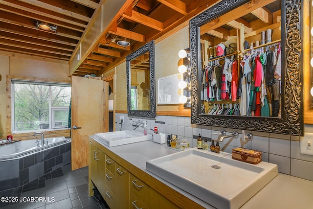 full bath featuring tile patterned floors, decorative backsplash, double vanity, and a sink