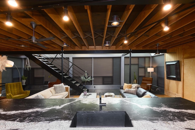 interior space featuring outdoor lounge area, a sink, and stairs