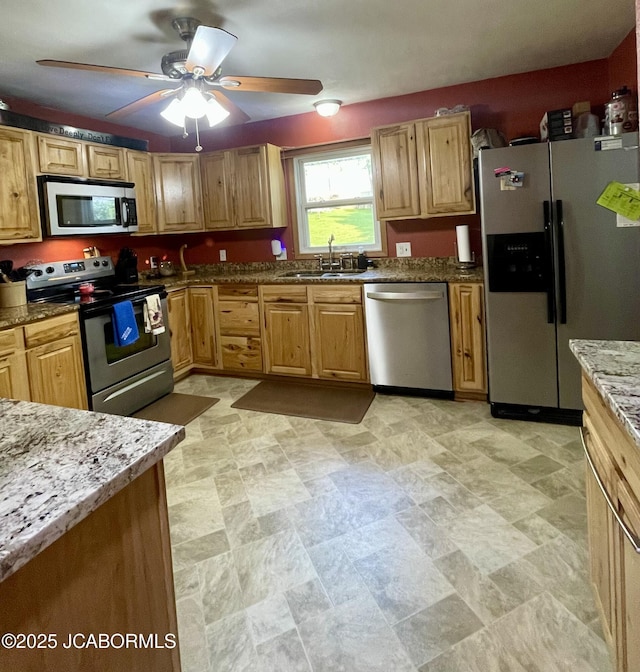 909 E Jefferson St, Linn, MO 65051 - kitchen featuring appliances with stainless steel finishes, a sink, stone counters, and a ceiling fan