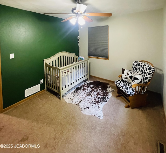 909 E Jefferson St, Linn, MO 65051 - carpeted bedroom featuring baseboards, a crib, and a ceiling fan