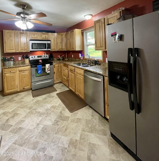 909 E Jefferson St, Linn, MO 65051 - kitchen featuring appliances with stainless steel finishes, a sink, dark stone countertops, and ceiling fan
