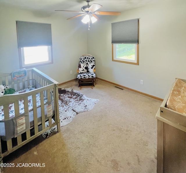 909 E Jefferson St, Linn, MO 65051 - carpeted bedroom featuring multiple windows, baseboards, and a nursery area