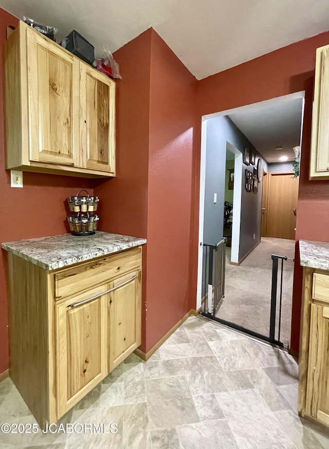 909 E Jefferson St, Linn, MO 65051 - kitchen with light brown cabinets, baseboards, and light stone counters