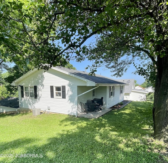 909 E Jefferson St, Linn, MO 65051 - back of house with a patio and a lawn